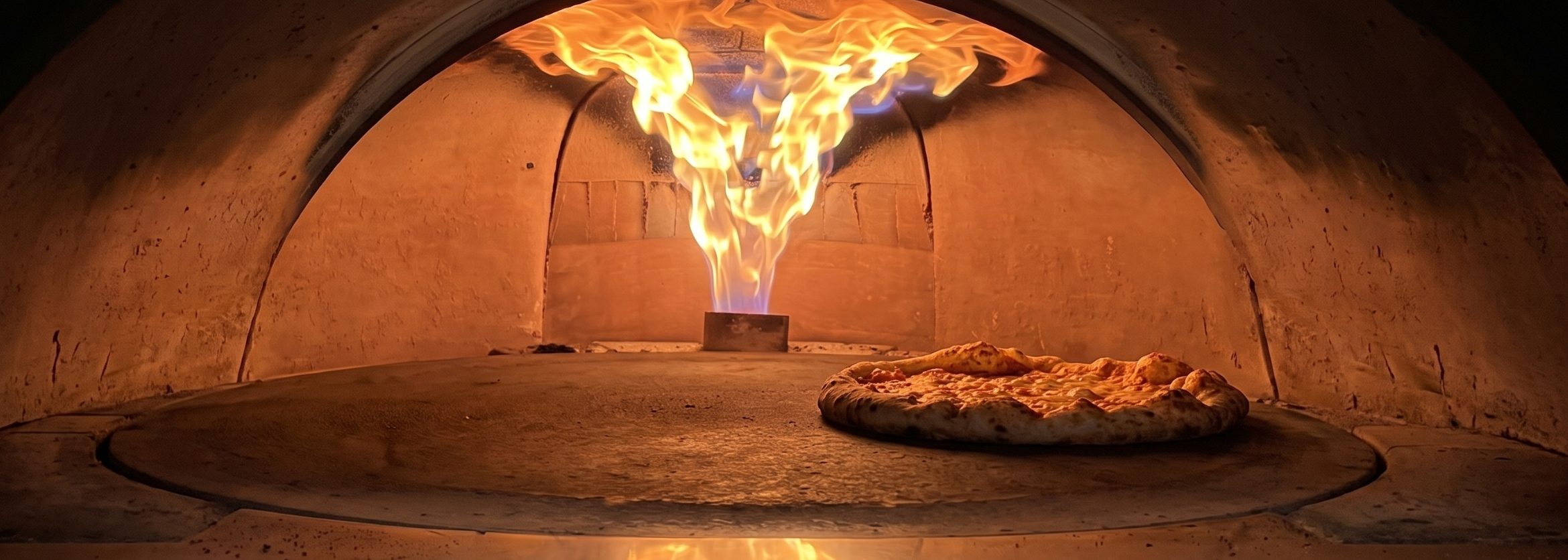A pizza baking on the stone in the brick oven at The Slice Pizzeria in Hahira, GA